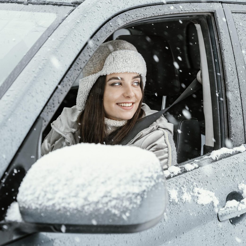 side-view-smiley-woman-driving-car-road-trip